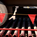Truckers using cleaning stations on Highway 30 to prevent gravel projections and improve road safety.