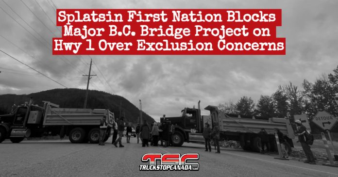 Dump trucks from the Splatsin First Nation Development Corporation block the R.W. Bruhn Bridge construction site in Sicamous, B.C., as part of a protest over exclusion from the project.