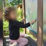 Photo of 3-year-old girl alongside an image of a grey 2007 Ford Escape with a “Baby on board!” sticker on the rear windshield. Both are central figures in an active police search.