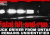 Suspect Released After Fatal Crash on Highway 20 Near Saint-Hyacinthe Black-and-white image of a police car with flashing emergency lights, overlaid with bold red and white headline text: “Fatal crash - hit-and-run: Truck driver from Ontario remains unidentified,” published by TruckStopCanada.com.