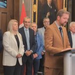 Xavier Barsalou-Duval surrounded by industry leaders including Marc Cadieux, Jean-Claude Daigneault, Éric Gignac, Yvan Domingue, and Réal Gagnon at a Bloc Québécois press conference in Ottawa on trucking reform.
