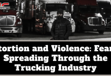 Extortion and Violence: Fear Is Spreading Through the Trucking Industry Black-and-white image of a man wearing a winter coat and beanie standing in front of several parked semi-trucks at night, with the TruckStopCanada logo at the top. Text on the image reads: “Extortion and Violence: Fear Is Spreading Through the Trucking Industry.”