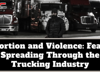 Extortion and Violence: Fear Is Spreading Through the Trucking Industry Black-and-white image of a man wearing a winter coat and beanie standing in front of several parked semi-trucks at night, with the TruckStopCanada logo at the top. Text on the image reads: “Extortion and Violence: Fear Is Spreading Through the Trucking Industry.”